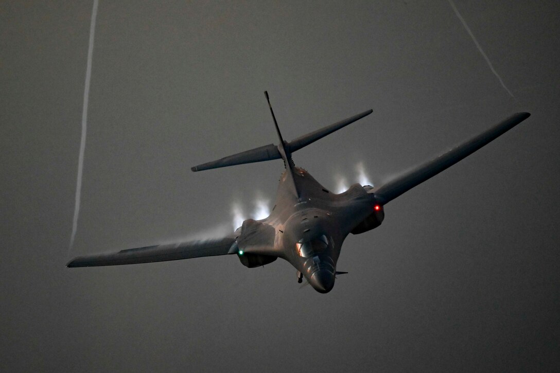 A military aircraft flies toward the camera.