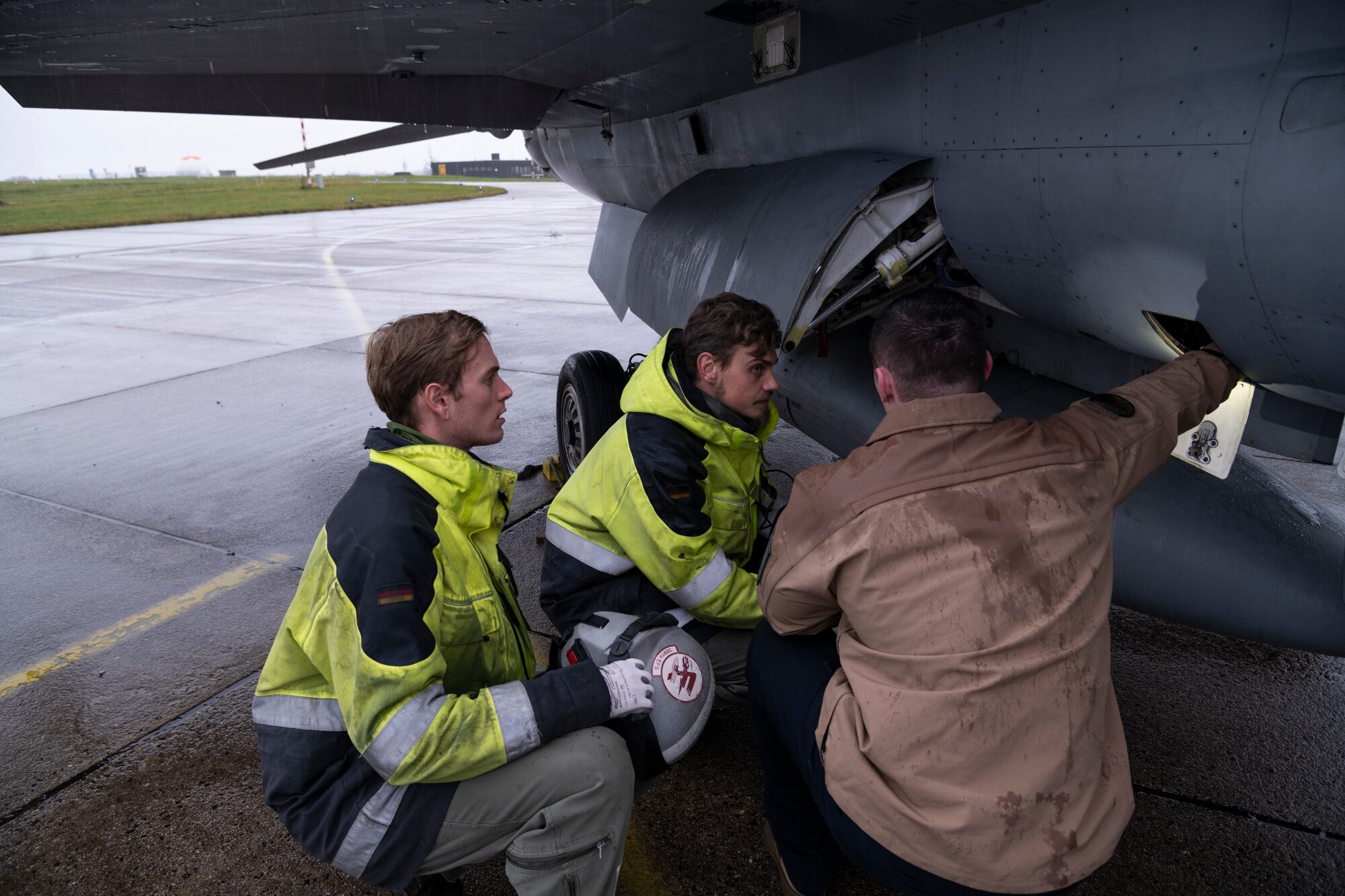 U.S. Air Force Staff Sgt. Kostyantyn Morozyuk, 52nd Aircraft Maintenance Squadron crew chief, instructs German Air Force aircraft maintainers on how to perform pre-flight checks on an F-16C Fighting Falcon fighter jet prior to takeoff at Büchel Air Base, Germany, Nov. 3, 2021. Participation in multinational exercises like Castle Forge enhances our professional relationships and improves overall coordination with allies and partner militaries during a time of crisis. (U.S. Air Force photo by Senior Airman Ali Stewart)