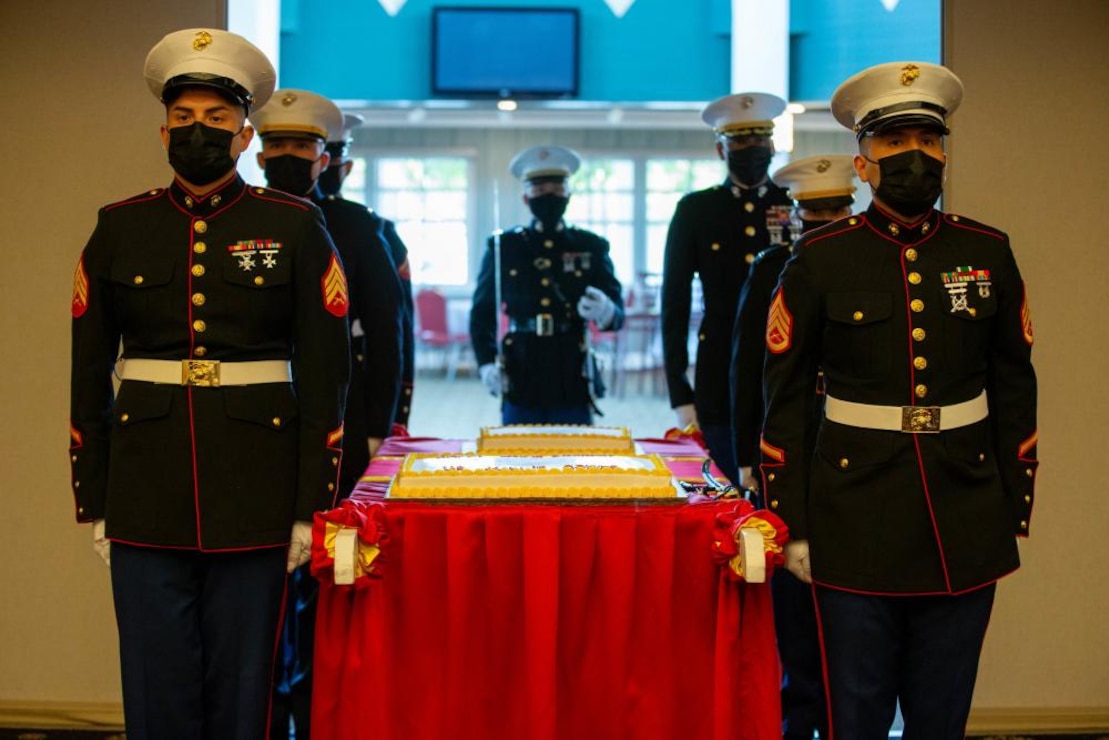 Marines with Marine Corps Recruiting Command march on the cake during the Cake Cutting Ceremony for the 246th Marine Corps Birthday at the Clubs of Quantico, Marine Corps Base Quantico, VA, on November 4, 2021. The Cake Cutting Ceremony is an annual tradition representing an annual renewal of each Marines commitment to the Corps, and The Corps’ commitment to passing on knowledge and tradition from one generation to the next.