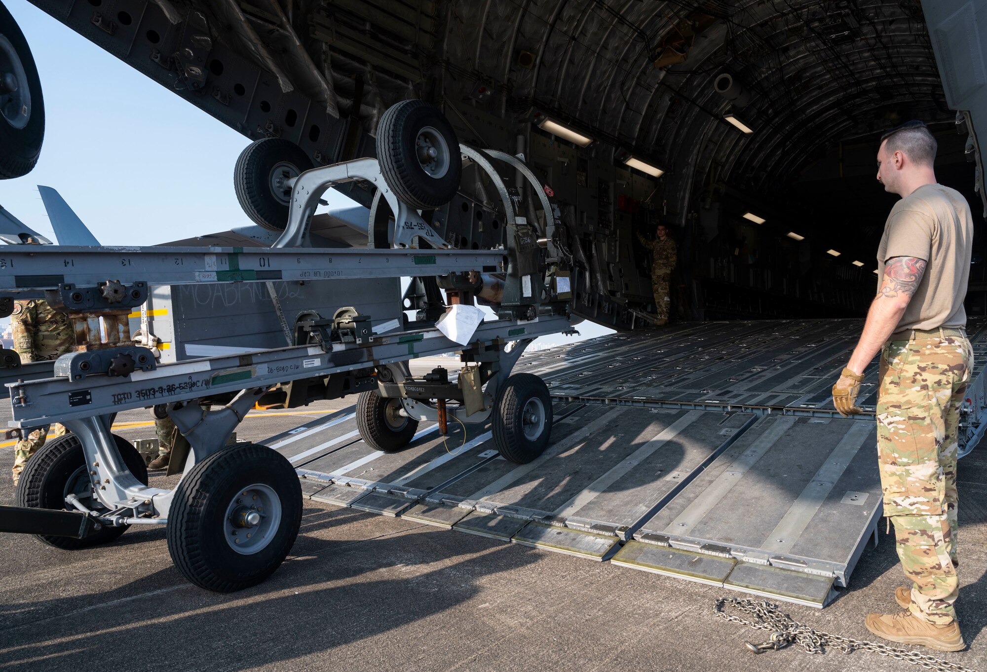 U.S. Airmen load equipment, belonging with the 14th Fighter Squadron, Misawa Air Base, Japan, onto a C-17 Globemaster III during Exercise Rainier War 21B in Daegu, South Korea, Nov. 6, 2021. The 62nd Airlift Wing provided transport for the 14th Fighter Squadron from Daegu, South Korea, to Misawa Air Base, Japan. Rainier War 21B exercised and evaluated the 62nd Airlift Wing’s ability to employ the force and their ability to perform during wartime and contingency taskings in a high-intensity, wartime contested, degraded and operationally limited environment while supporting the contingency operations against a near-peer adversary in the U.S. Indo-Pacific Command area of responsibility. (U.S. Air Force photo by Staff Sgt. Rachel Williams)