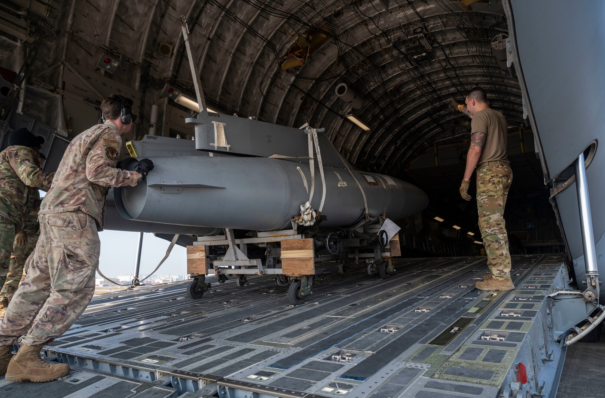 U.S. Airmen load F-16 Fighting Falcon fuel tanks onto a C-17 Globemaster III during Exercise Rainier War 21B in Daegu, South Korea, Nov. 6, 2021. The 62nd Airlift Wing provided transport for the 14th Fighter Squadron from Daegu, South Korea, to Misawa Air Base, Japan. Rainier War is a semi-annual, large readiness exercise led by the 62nd Airlift Wing, designed to train aircrews under realistic scenarios that support full spectrum readiness operations against modern threats and replicate today’s contingency operations. (U.S. Air Force photo by Staff Sgt. Rachel Williams)