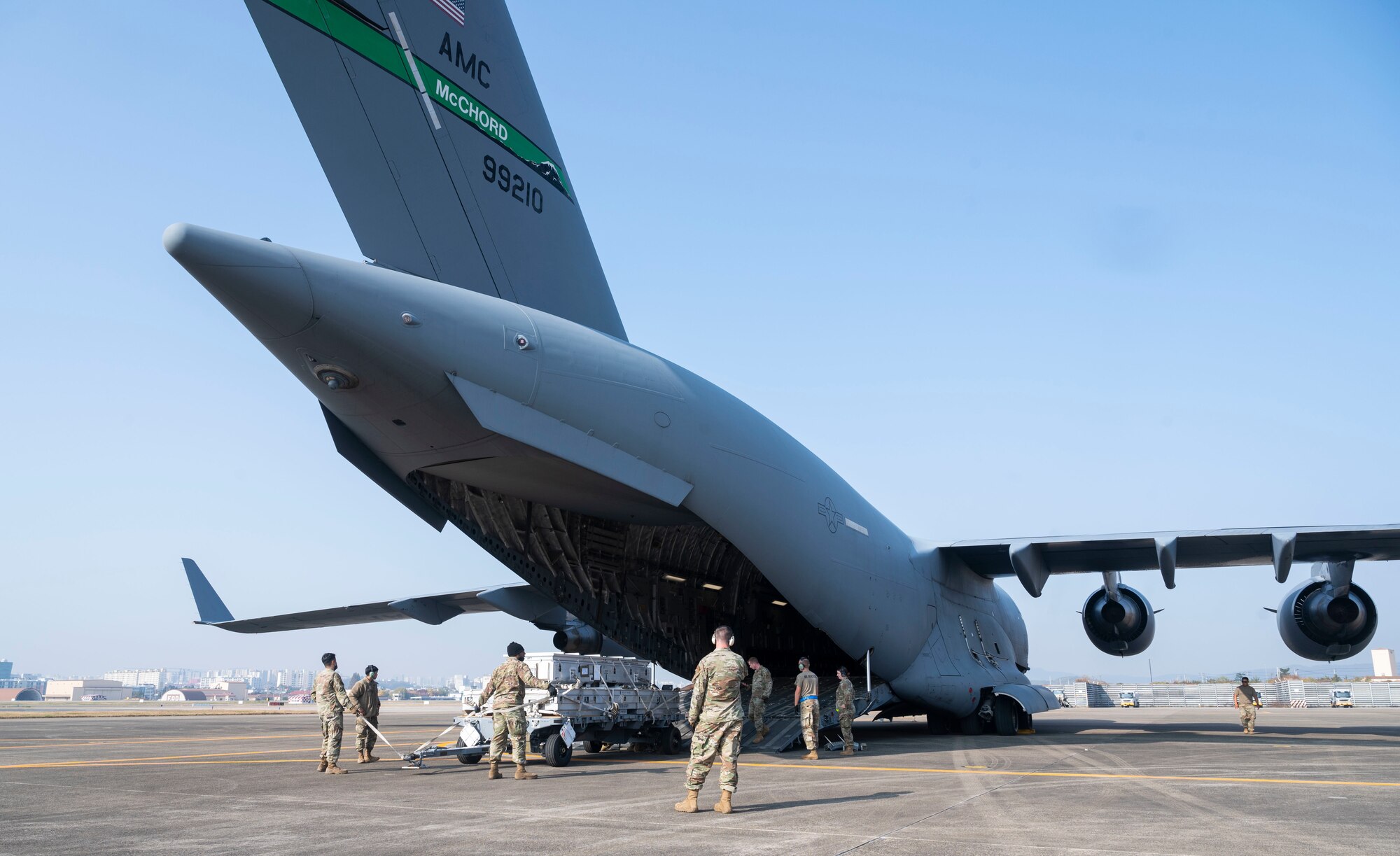 U.S. Airmen load equipment, belonging with the 14th Fighter Squadron, Misawa Air Base, Japan, onto a C-17 Globemaster III during Exercise Rainier War 21B in Daegu, South Korea, Nov. 6, 2021. The 62nd Airlift Wing provided transport for the 14th Fighter Squadron from Daegu, South Korea, to Misawa Air Base, Japan. Rainier War 21B exercised and evaluated the 62nd Airlift Wing’s ability to employ the force and their ability to perform during wartime and contingency taskings in a high-intensity, wartime contested, degraded and operationally limited environment while supporting the contingency operations against a near-peer adversary in the U.S. Indo-Pacific Command area of responsibility. (U.S. Air Force photo by Staff Sgt. Rachel Williams)
