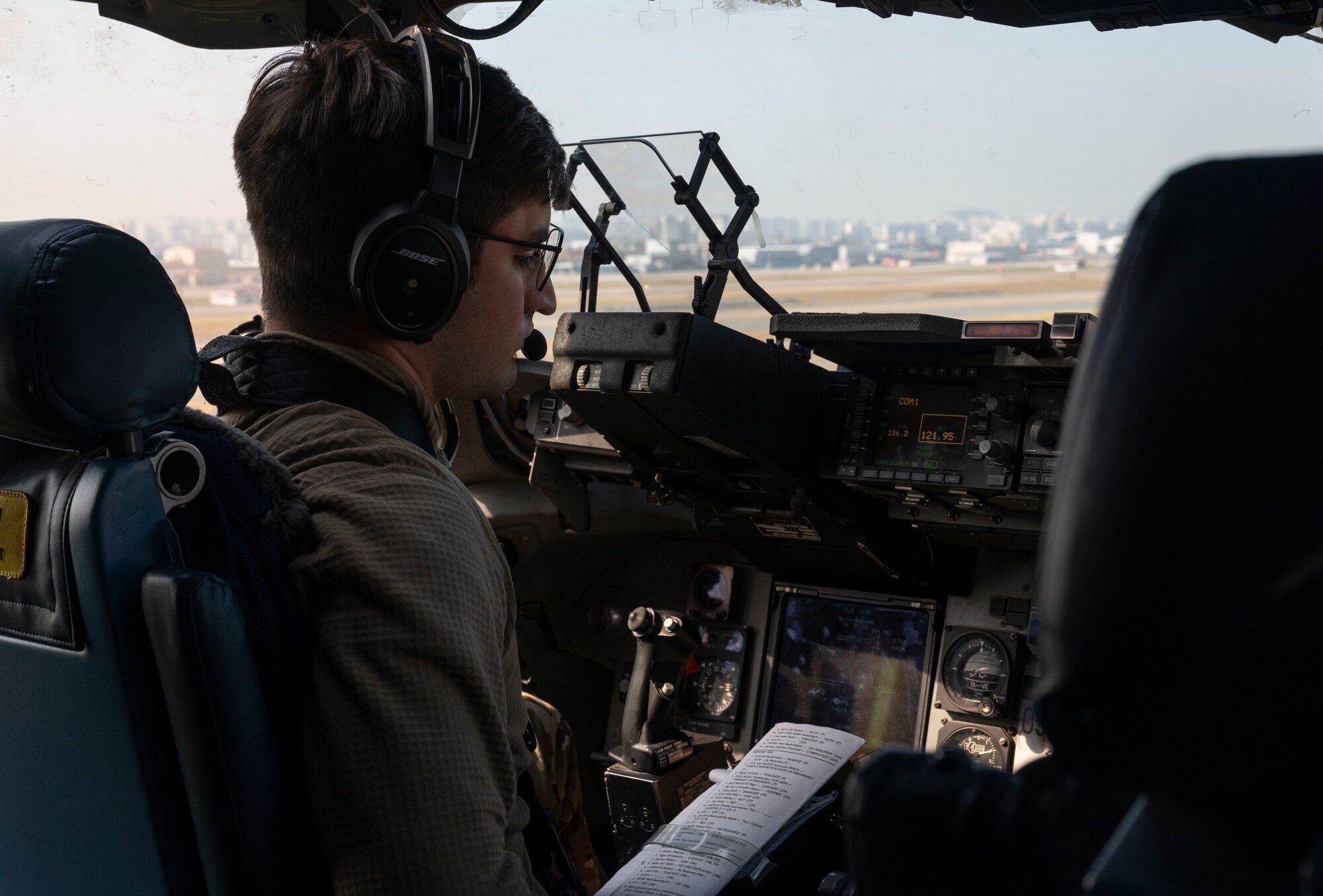 U.S. Air Force 1st Lt. Christopher Ferrario, a co-pilot with the 7th Airlift Squadron, conducts pre-flight checks prior to departing from Daegu, South Korea, Nov. 6, 2021, during Exercise Rainier War 21B. Rainier War 21B exercised and evaluated the 62nd Airlift Wing’s ability to employ the force and their ability to perform during wartime and contingency taskings in a high-intensity, wartime contested, degraded and operationally limited environment while supporting the contingency operations against a near-peer adversary in the U.S. Indo-Pacific Command area of responsibility. (U.S. Air Force photo by Staff Sgt. Rachel Williams)