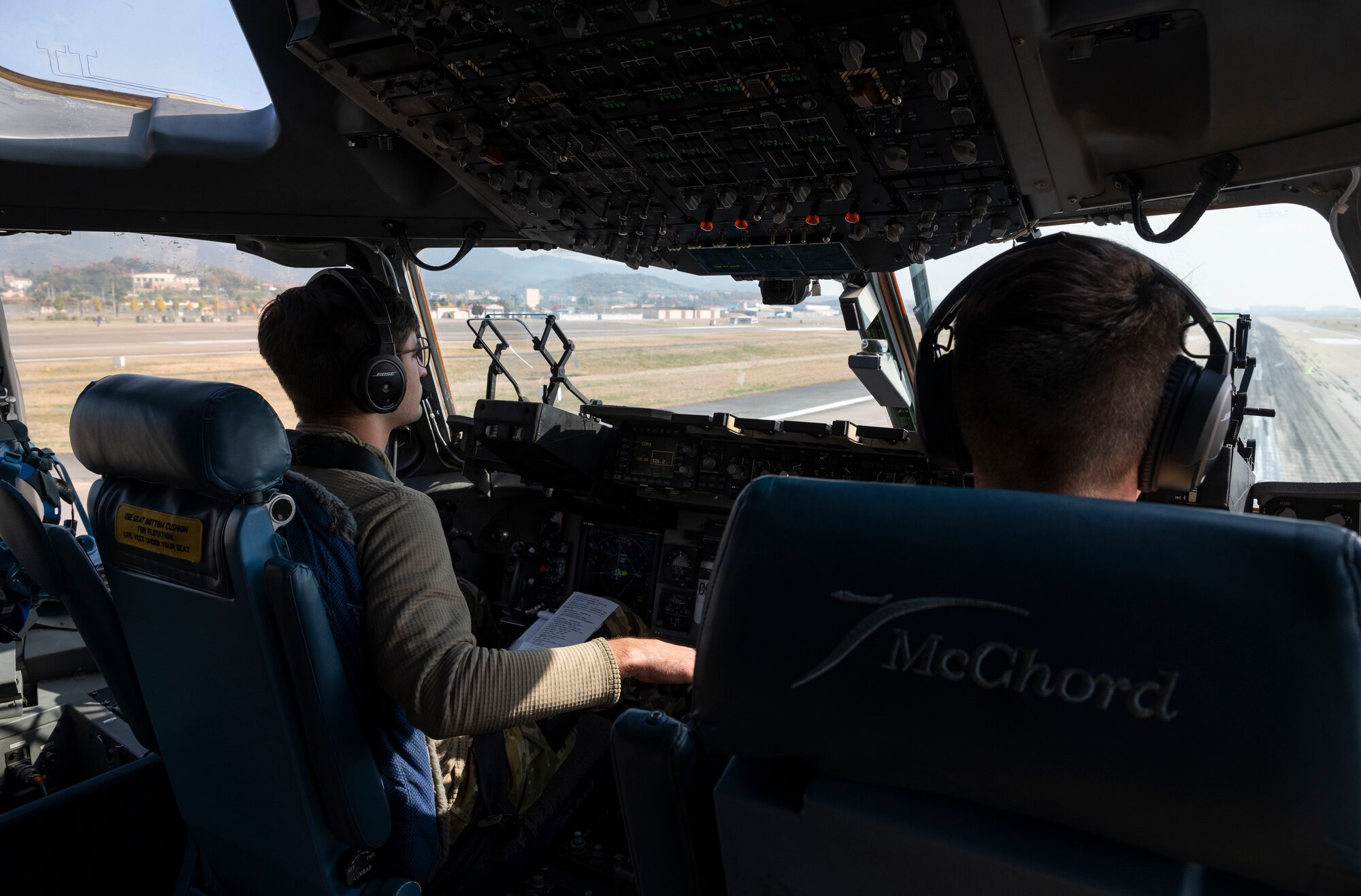 U.S. Air Force 1st Lt. Christopher Ferrario, left, a co-pilot with the7th Airlift Squadron, and U.S. Air Force Maj. John Greenway, a pilot with the 7th AS, takeoff in a C-17 Globemaster III from Daegu, South Korea, Nov. 6, 2021, during Exercise Rainier War 21B. Rainier War is a semi-annual, large readiness exercise led by the 62nd Airlift Wing, designed to train aircrews under realistic scenarios that support full spectrum readiness operations against modern threats and replicate today’s contingency operations. (U.S. Air Force photo by Staff Sgt. Rachel Williams)