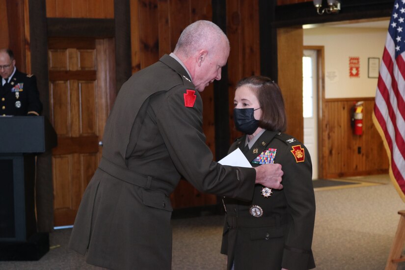 Maj. Gen. Mark Schindler, adjutant general of Pennsylvania, presents the Legion of Merit award to Brig. Gen. Laura McHugh on Nov. 6, 2021, at Fort Indiantown Gap, Pa.  She was presented the award in recognition of her work as chief of staff, Pa. Army National Guard. (Photo by Lt. Col. Keith Hickox)