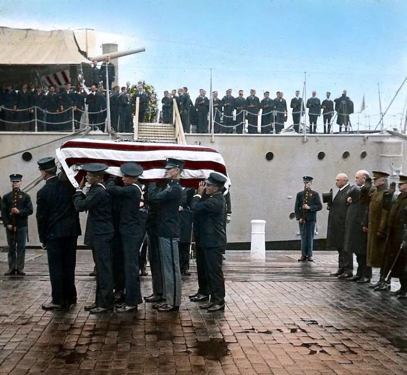 Body bearers carry a casket.