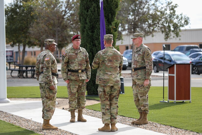 Command Sgt. Maj. Ryan T. Bodmer (center front), senior enlisted advisor for the 351st Civil Affairs Command, acts as custodian of the colors during the change of command ceremony between outgoing commander, Brig. Gen. Isaac Johnson, Jr.(left), and incoming commander, Brig. Gen. Christopher J. Dziubek (right), during the change of command ceremony at the Sgt. James Witkowski Armed Forces Reserve Center, Mountain View, California, Saturday, Nov. 6, 2021.