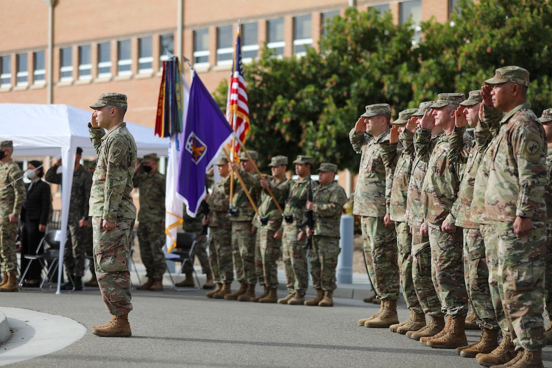 Soldiers of the 351st Civil Affairs Command render honors to the flag as the National Anthem plays at the change of command ceremony between Brig. Gen. Isaac Johnson, Jr., outgoing commanding general, and Brig. Gen. Christopher J. Dziubek, incoming commanding general, at the Sgt. James Witkowski Armed Forces Reserve Center, Mountain View, California, Saturday, Nov. 6, 2021.