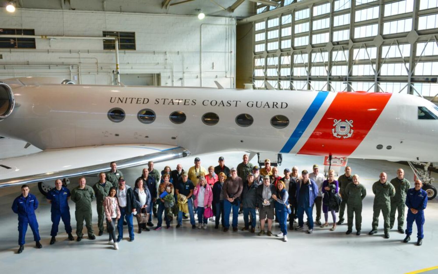 Coast Guard crewmembers and Vietnam veterans from the Coast Guard Cutter Owasco (WHEC-39), a 255-foot high endurance cutter, pose for a photo at Coast Guard Air Station Washington, Nov. 5, 2021. The veterans were given an air station tour and were presented with official lapel pins commemorating their service and for the 50th anniversary of the Vietnam War. (U.S. Coast Guard photo by Petty Officer 1st Class Tara Molle-Carr/Released)