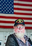 Bill Leggett, a Coast Guard Vietnam veteran, poses for a photo during a tour given to Coast Guard Vietnam veterans from the Coast Guard Cutter Owasco at Coast Guard Air Station Washington, Nov. 5, 2021. A Lexington, Ky., native, Leggett is a former 3rd class boatswain's mate aboard the cutter and was one of several veterans who was presented with an official lapel pin commemorating their service and for the 50th anniversary of the Vietnam War. (U.S. Coast Guard photo by Petty Officer 1st Class Tara Molle-Carr/Released)