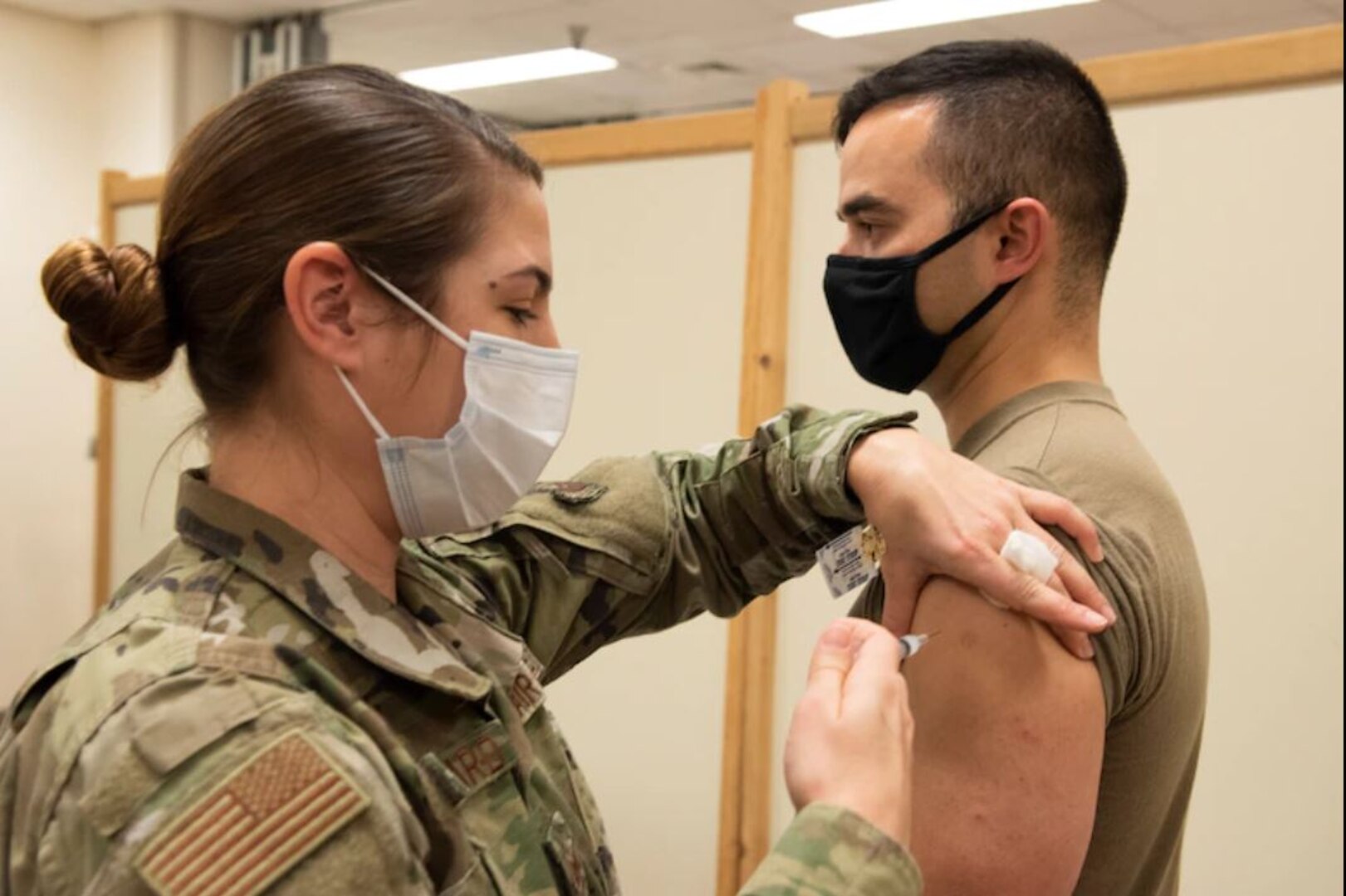 U.S. Air Force Staff Sgt. Kayla Blanchard, 39th Medical Group Immunization technician, administers a COVID-19 vaccination to Capt. Brent Luch, 39th Security Forces Squadron operations officer, during the initial series of vaccinations Jan. 8, 2021, at Incirlik Air Base, Turkey. Prioritized DoD personnel are highly encouraged to take the vaccine to protect their health, their families, their community, and lower the public health risks associated with the COVID-19 pandemic. (U.S. Air Force photo by Staff Sgt. Ryan Lackey)