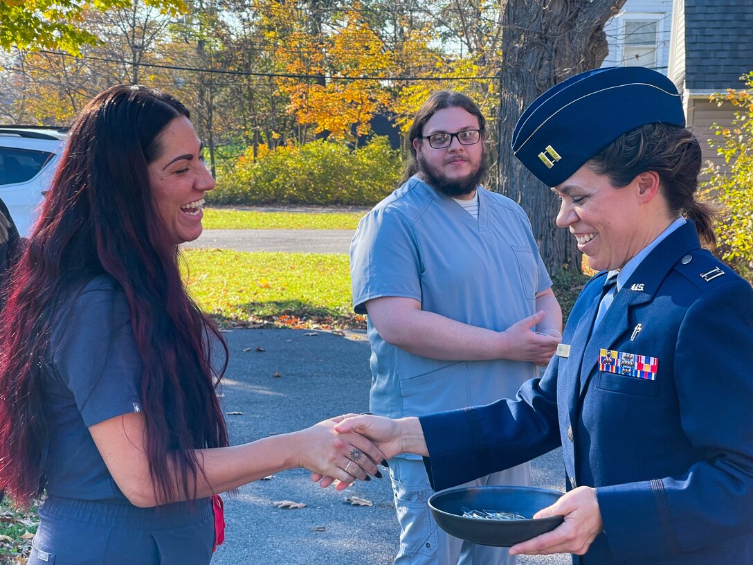 Chaplain coins dental technician outside their dental office
