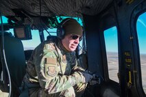 Maj. Gen Michael Lutton, 20th Air Force Commander, rides in a helicopter assigned to the 54th Helicopter Squadron at Minot Air Force Base, ND, Oct. 28, 2021. Maj. Gen. Lutton had the opportunity to observe  a training exercise with the Tactical Response Force from Minot AFB. (U.S. Air Force photo by Airman 1st Class Saomy Sabournin)
