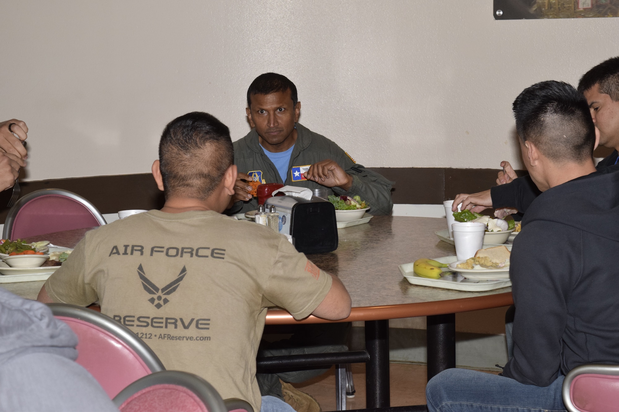 Col. Nikhil Patel, 433rd Airlift Wing vice commander, eats lunch with the Development and Training Flight members Nov. 6, 2021, at Joint Base San Antonio-Lackland, Texas. The D&TF program educates incoming Air Force members on military customs and connects them with the unit to help them transition from civilian to military service. (U.S. Air Force photo by Senior Airman Brittany Wich)