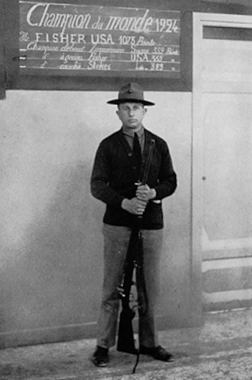 A Marine stands with a rifle.