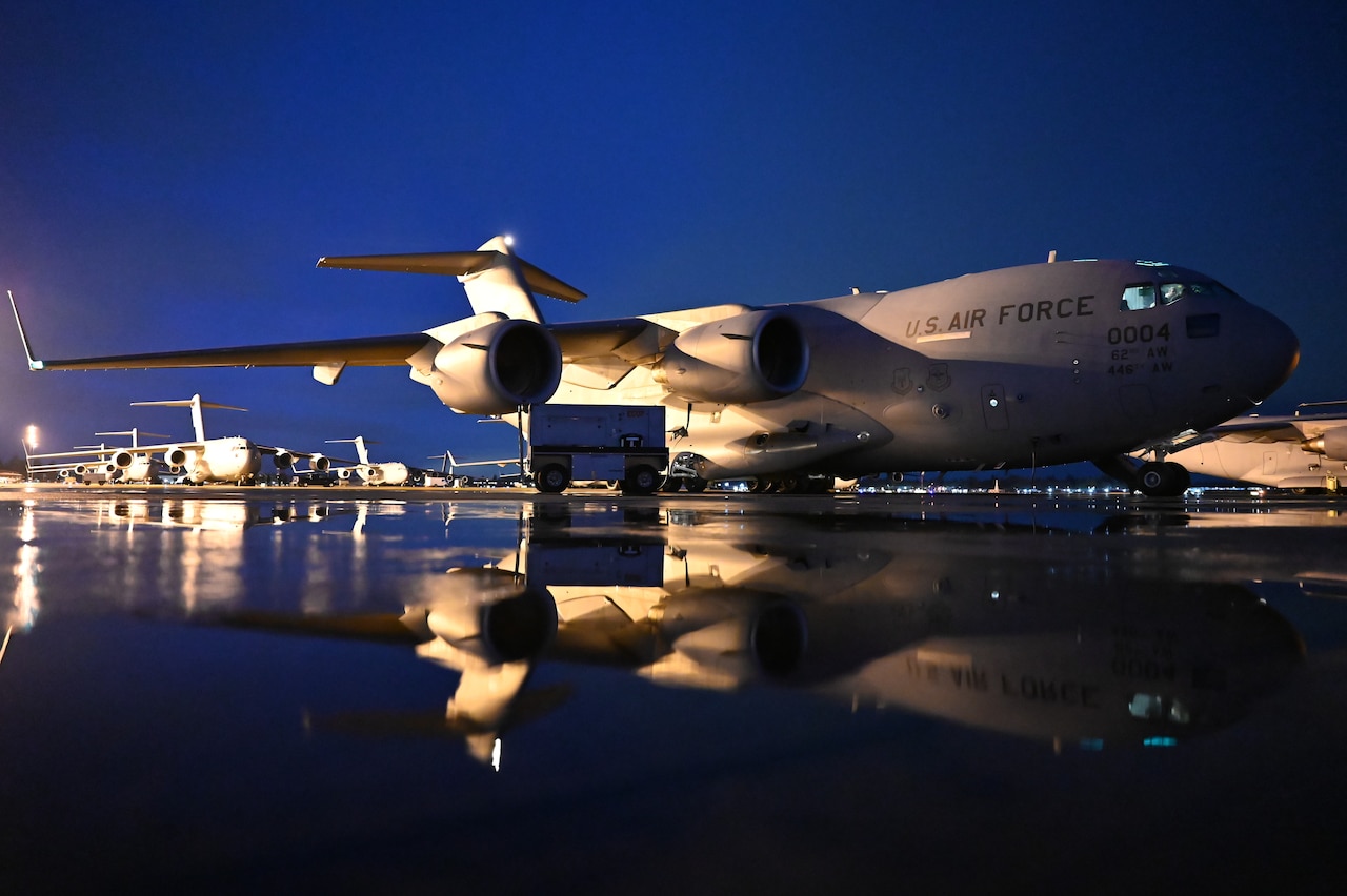 A parked plane at night.