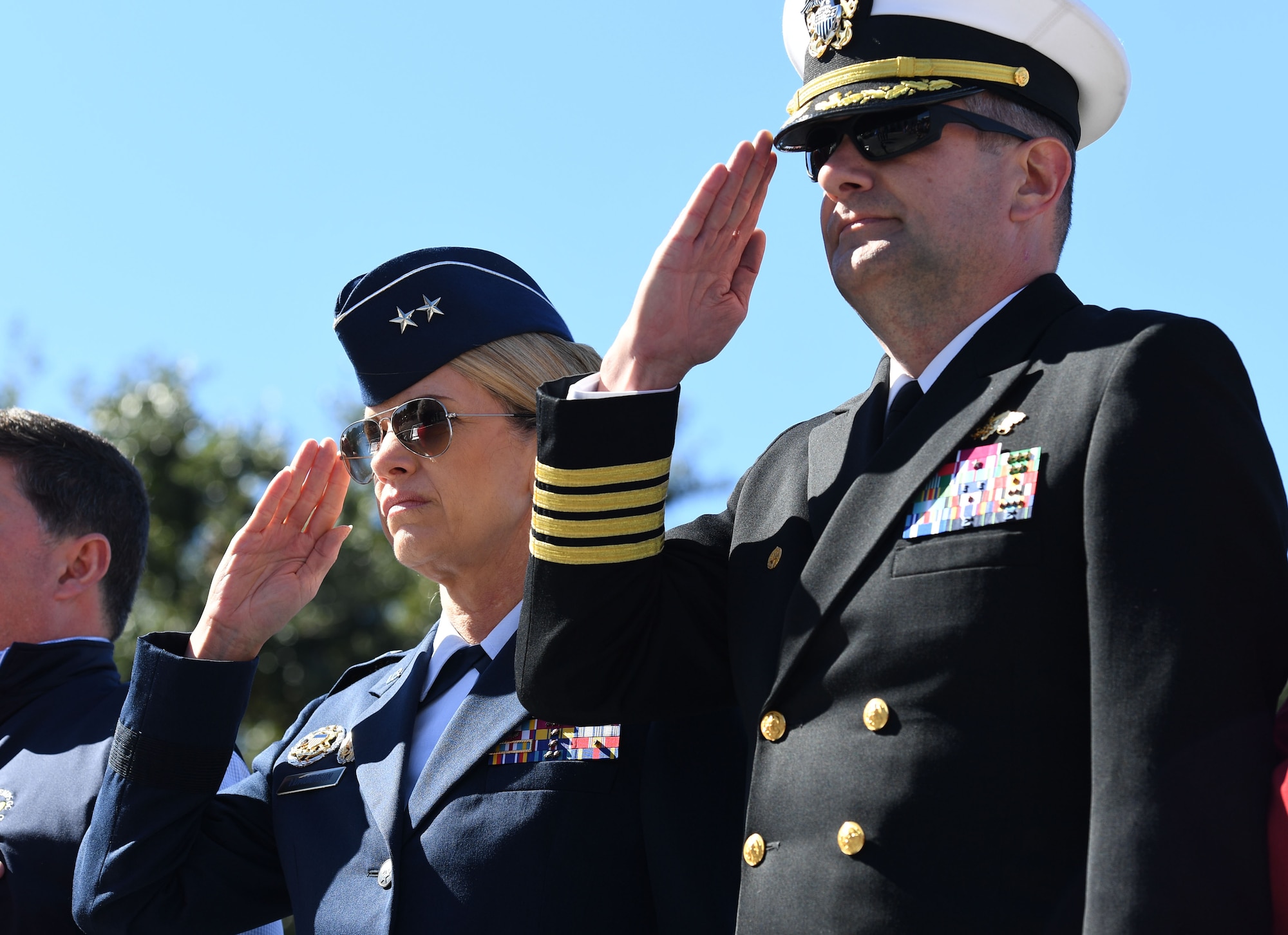U.S. Air Force Maj. Gen. Michele Edmondson, Second Air Force commander, and U.S. Navy Capt. Jeff Powell, Naval Construction Battalion Center commander, Gulfport, Mississippi, render a salute during the 21st Annual Gulf Coast Veterans Day Parade in Biloxi, Mississippi, Nov. 6, 2021. Keesler Air Force Base leadership, along with hundreds of Airmen, attended and participated in the parade in support of all veterans, past and present. More than 50 unique floats, marching bands and military units marched in the largest Veterans Day parade on the Gulf Coast. (U.S. Air Force photo by Kemberly Groue)