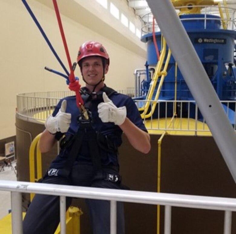 Bennett Moore rappels down a turbine in the power house at Lower Granite Lock and Dam.