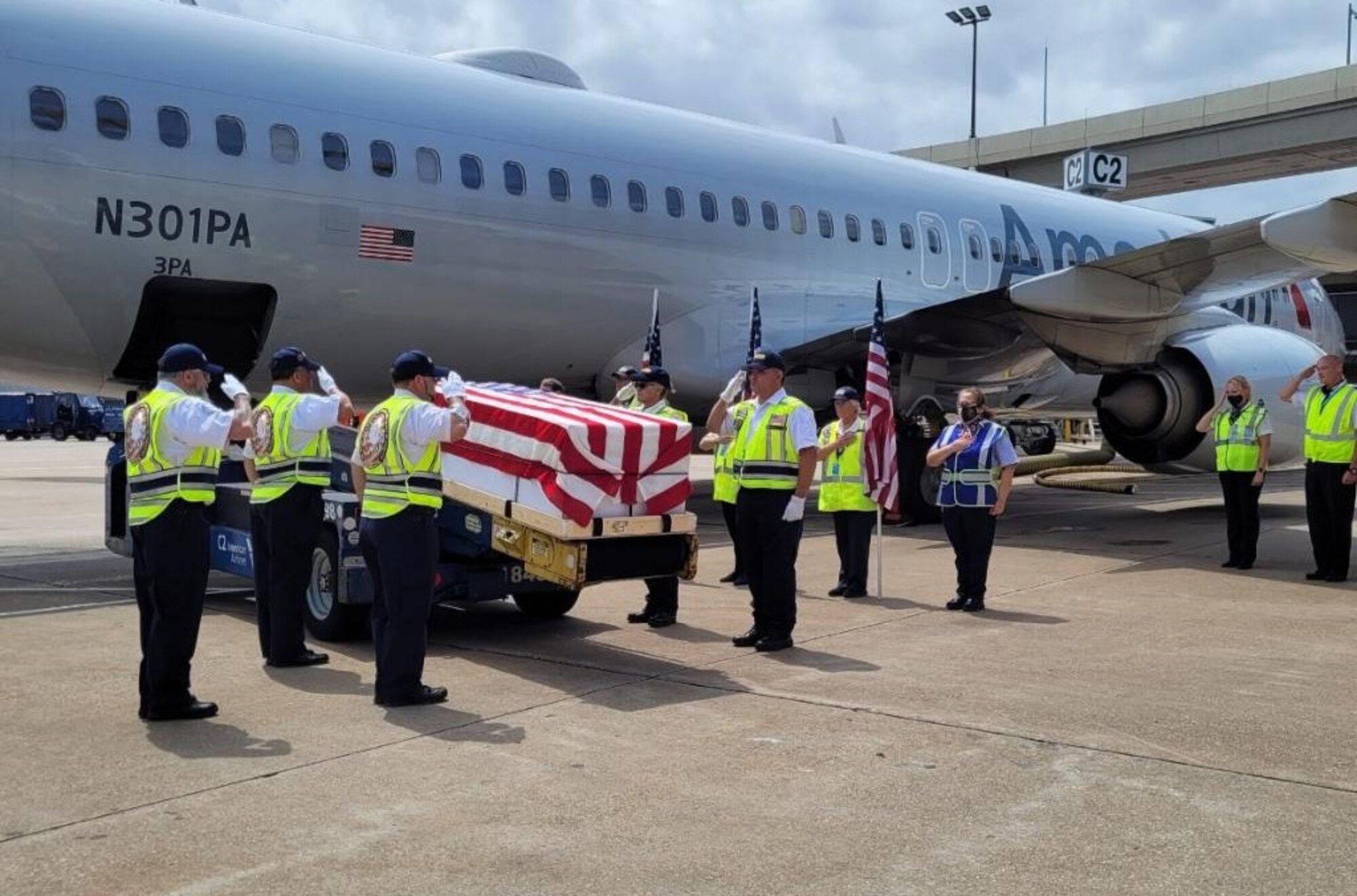 The American Airlines Honor Team at Dallas-Fort Worth Airport prepares to transfer the remains of Army Cpl. Norvin D. Brockett to the flight that will take him to Washington, D.C. for burial at Arlington National Cemetery.