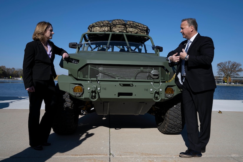 The deputy defense secretary speaks with the president of General Motors Defense.