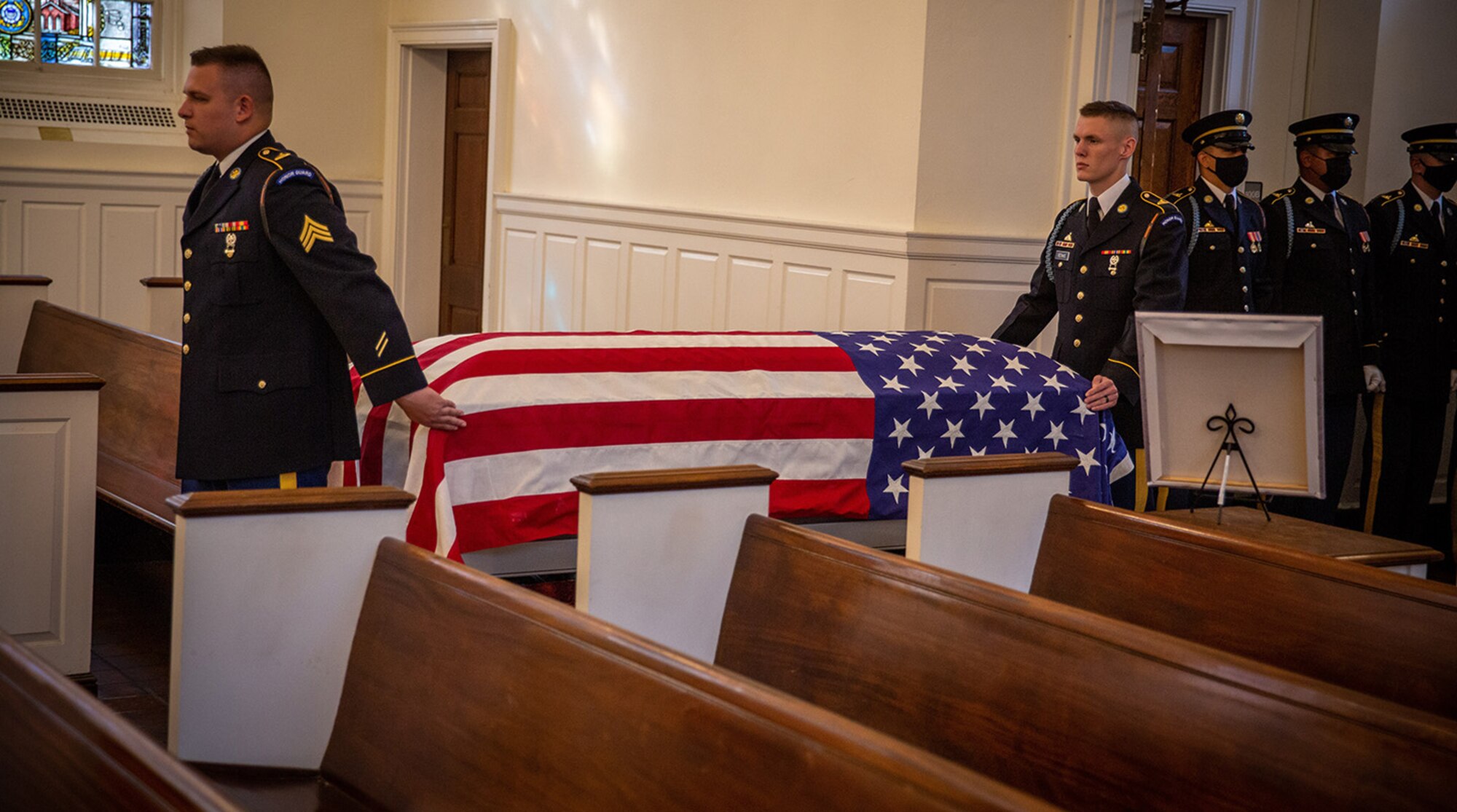 Members of the Arlington National Cemetery Casket Team escort the casket of Army Cpl. Norvin D. Brockett into the Fort Myer, Va., Old Post Chapel.