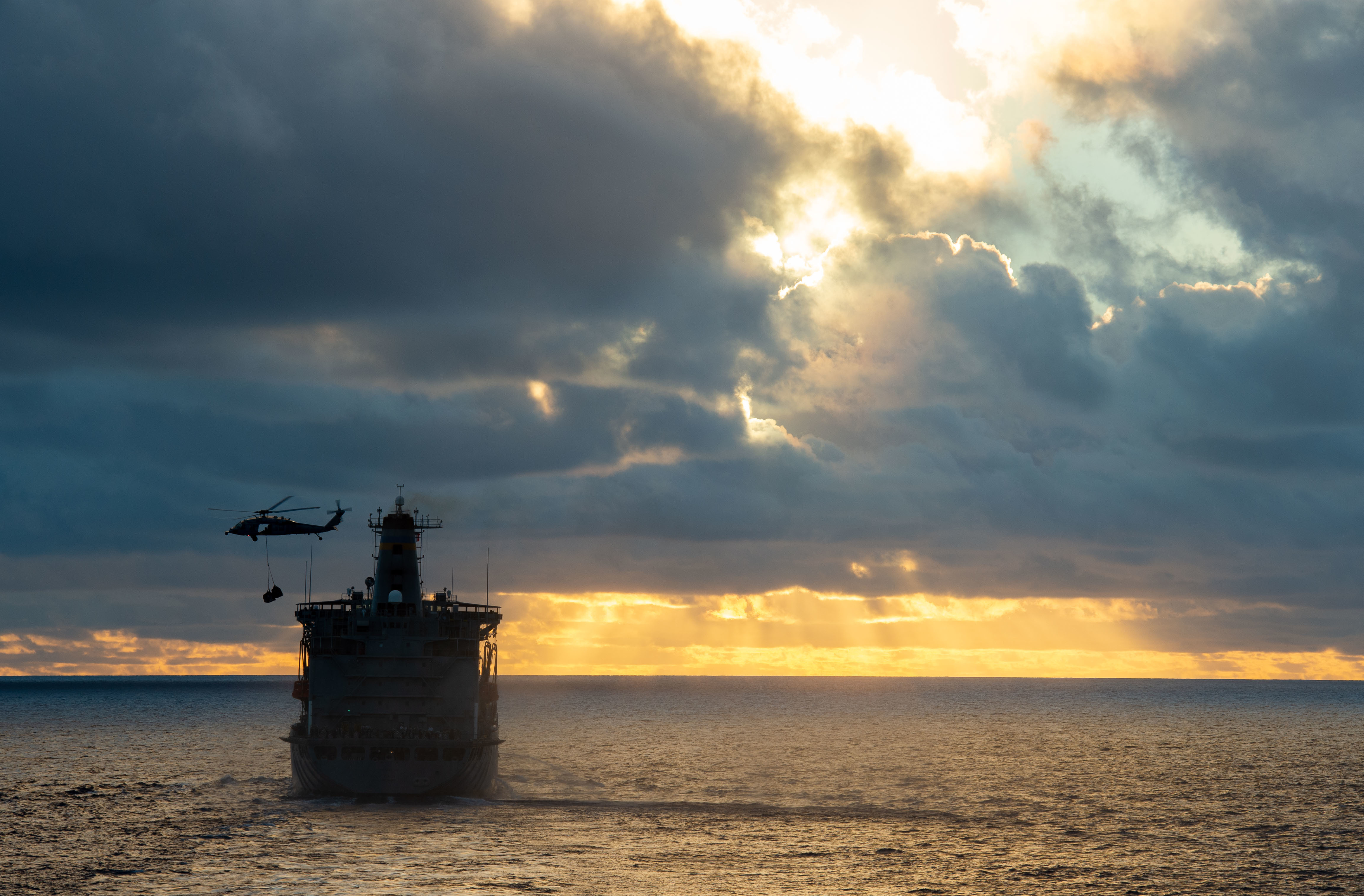 An MH-60S Sea Hawk, assigned to the "Island Knights" of Helicopter Sea Combat Squadron (HSC) 25, transports supplies to the Nimitz-class aircraft carrier USS Carl Vinson (CVN 70) during a vertical replenishment-at-sea with the Henry J. Kaiser-class fleet replenishment oiler USNS Yukon (T-AO 202).