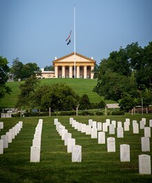 The flag flies at half-staff in front of Arlington House. The flags in Arlington National Cemetery are flown at half-staff from a half hour before the first funeral until a half hour after the last funeral each service.