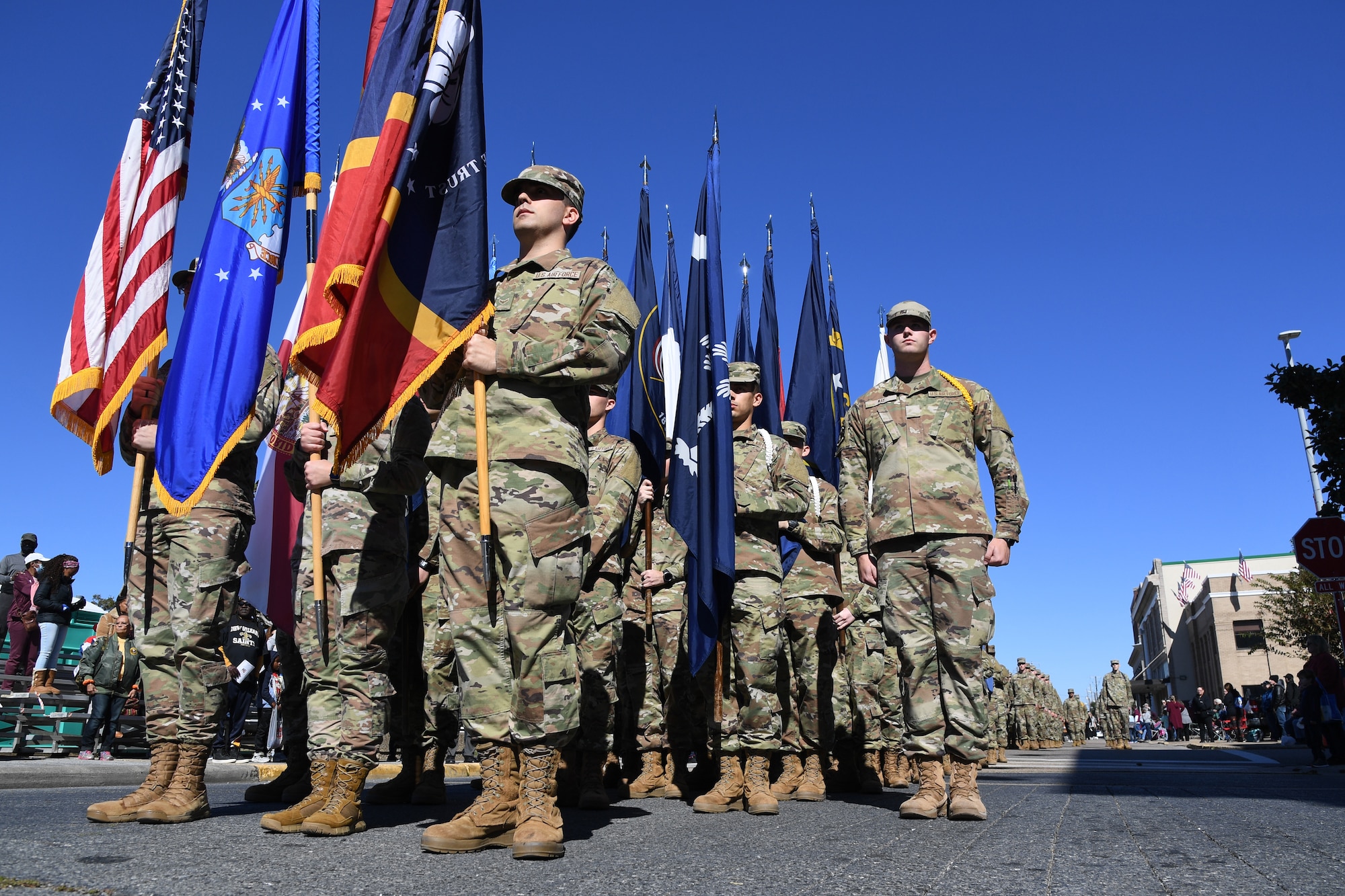 Airmen from the 81st Training Group carrying the 50 state flags march in the 21st Annual Gulf Coast Veterans Day Parade in Biloxi, Mississippi, Nov. 6, 2021. Keesler Air Force Base leadership, along with hundreds of Airmen, attended and participated in the parade in support of all veterans, past and present. More than 50 unique floats, marching bands and military units marched in the largest Veterans Day parade on the Gulf Coast. (U.S. Air Force photo by Kemberly Groue)