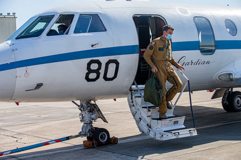A member of the French Navy off-boards the French maritime surveillance aircraft, Falcon F200, also known as "Gardian," prior to its departure on Marine Corps Air Station Futenma, Okinawa, Japan, Nov. 2, 2021. The arrival and departure of the aircraft on MCAS Futenma, one of the seven UNC-R bases in Japan, shows a continuous partnership between the UNC-R and the host nation. (U.S. Marine Corps photo by Lance Cpl. Alex Fairchild)