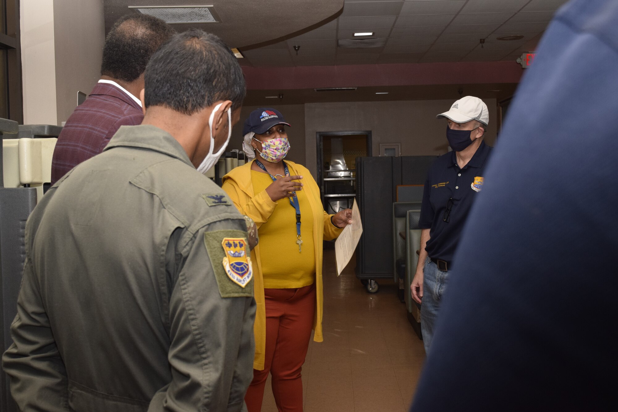 Alecia Sonnier, Food Service Corporation, briefs 433rd Airlift Wing senior leaders and honorary commanders prior to them serving a Thanksgiving meal to Reserve Citizen Airmen at the Live Oak Dining Facility at Joint Base San Antonio-Lackland, Texas Nov. 6, 2021. Following the meal, the leaders and honorary commanders visited with the Airmen in a relaxed environment. (U.S. Air Force photo by Senior Airman Brittany Wich)