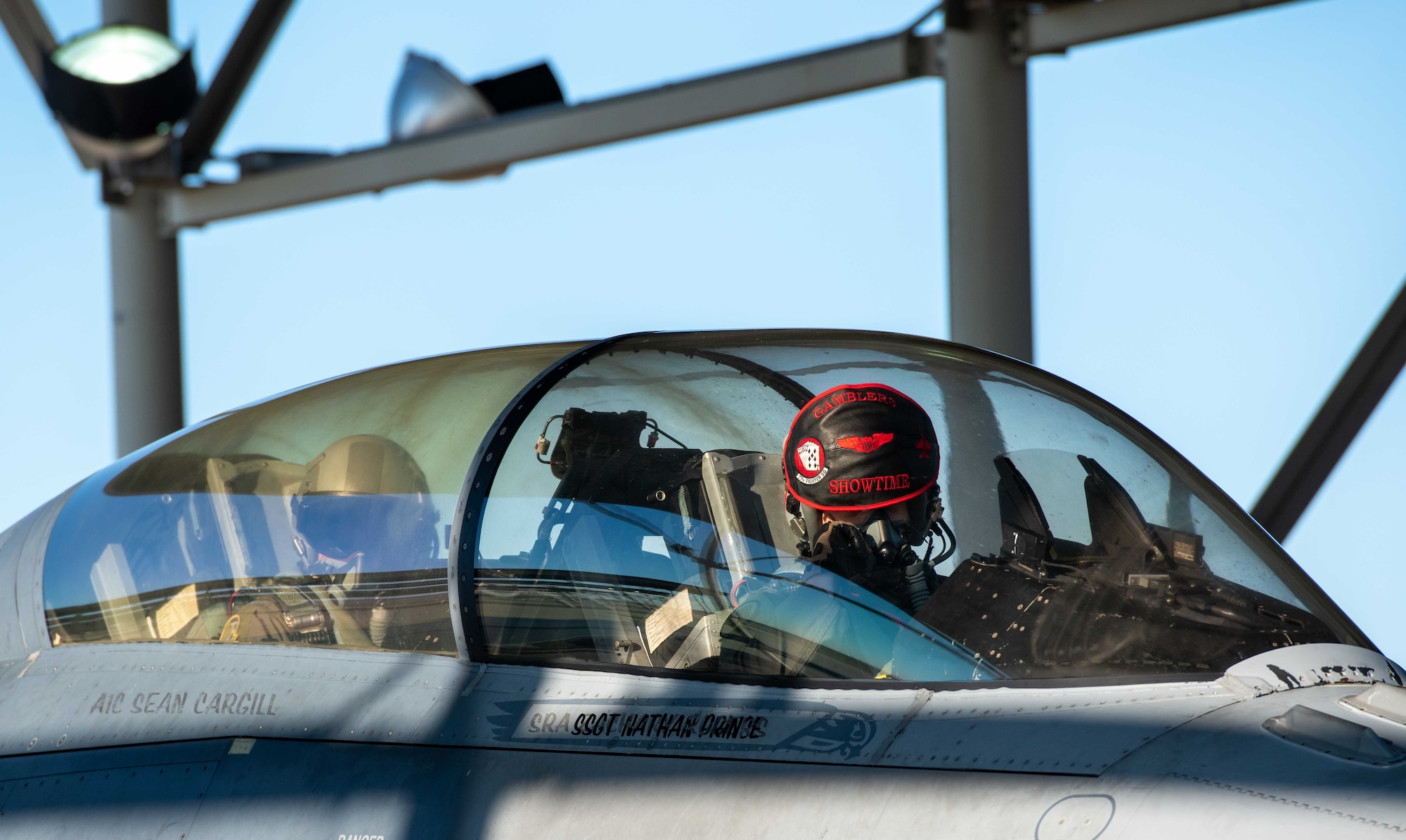 Photo of two pilots in an aircraft.