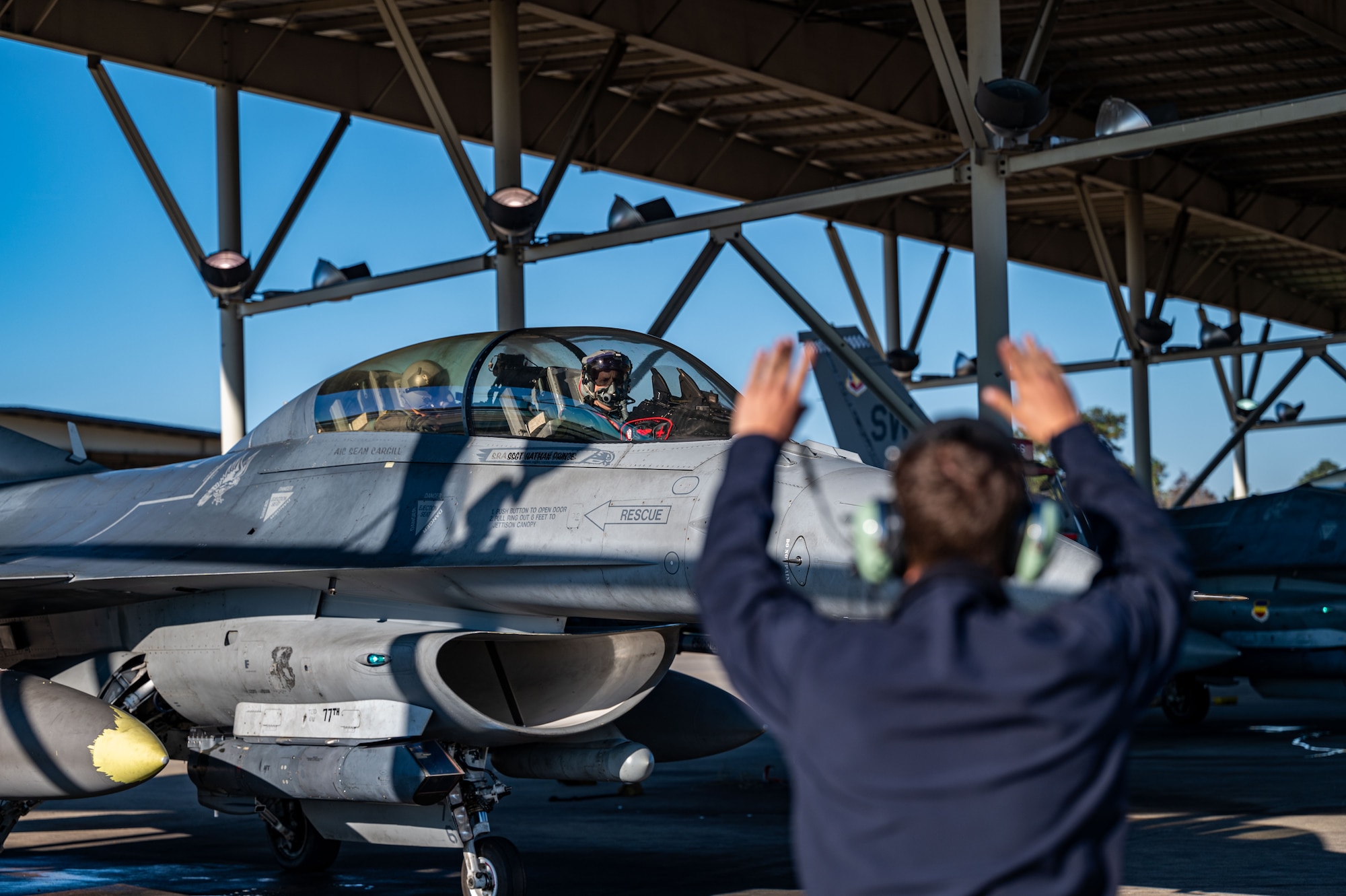 Photo of an Airman in front of jet.