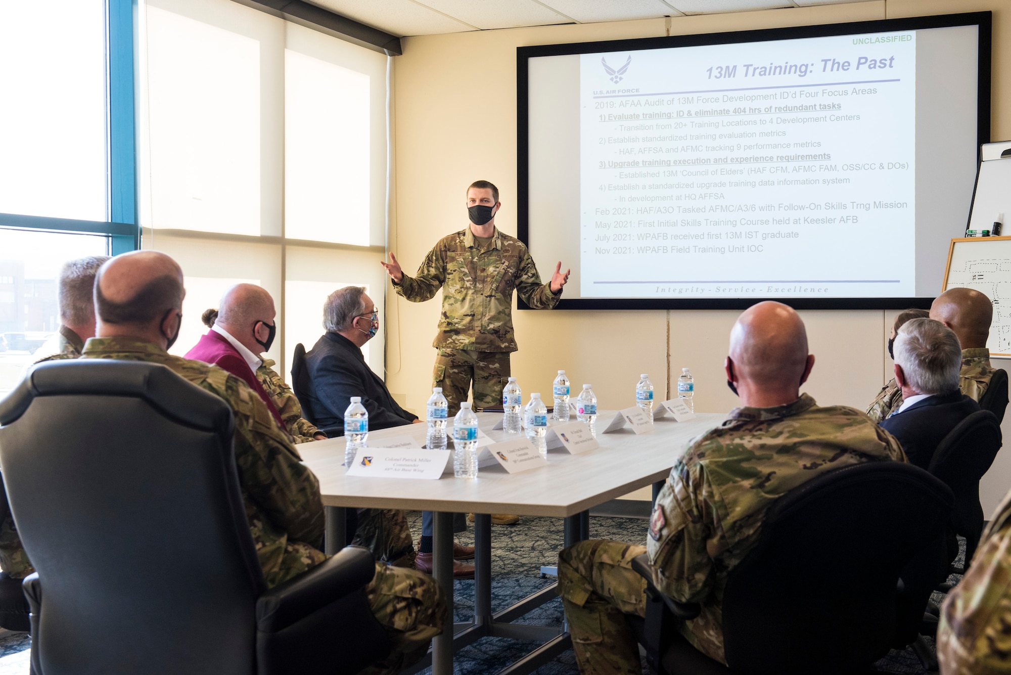 Maj. Hollis Troxel, 88th Operations Support Squadron director of operations, gives a presentation to base officials during the opening of the 13M Follow-On Skills Training facility at Wright-Patterson AFB, Nov. 3, 2021. Wright-Patt’s 13M training facility is the first of four to open nationwide in an effort by the Air Force to standardize and accelerate the program. (U.S. Air Force photo by Jaima Fogg)