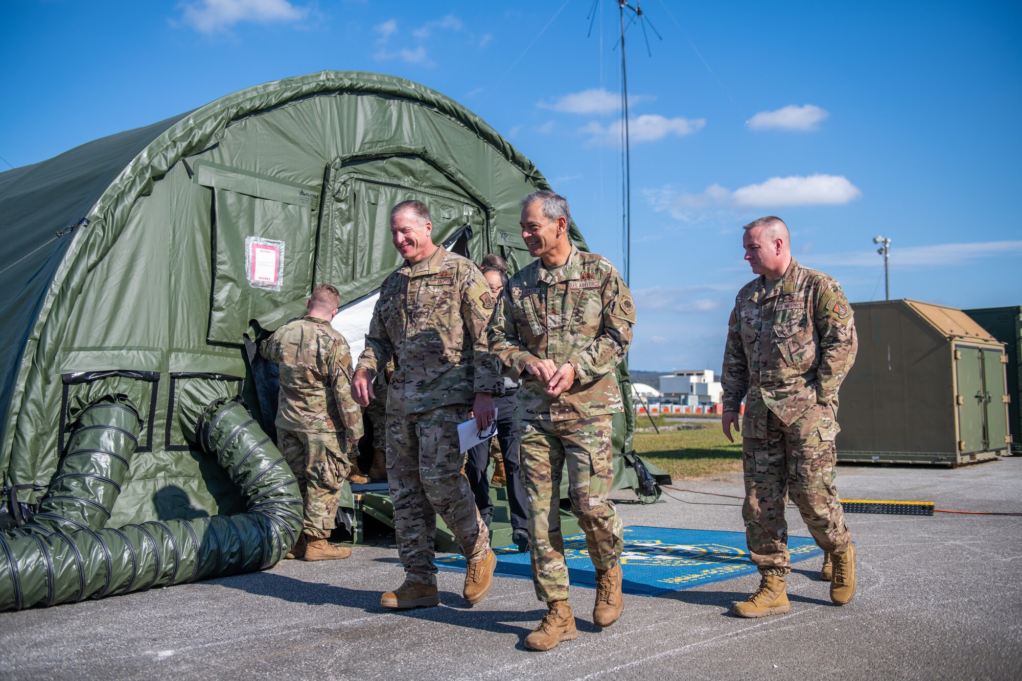 A U.S. Air Force Brigadier General laughs and talks with a U.S. Air Force General outside of an operational tent