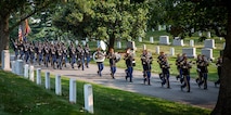 Members of the U.S. Army Band are followed by a military marching element during the transfer of Army Cpl. Norvin D. Brockett to his burial site at Arlington National Cemetery on July 21, 2021.