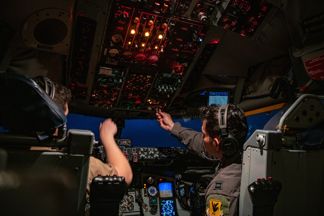 A photo of two pilots inside a KC-135