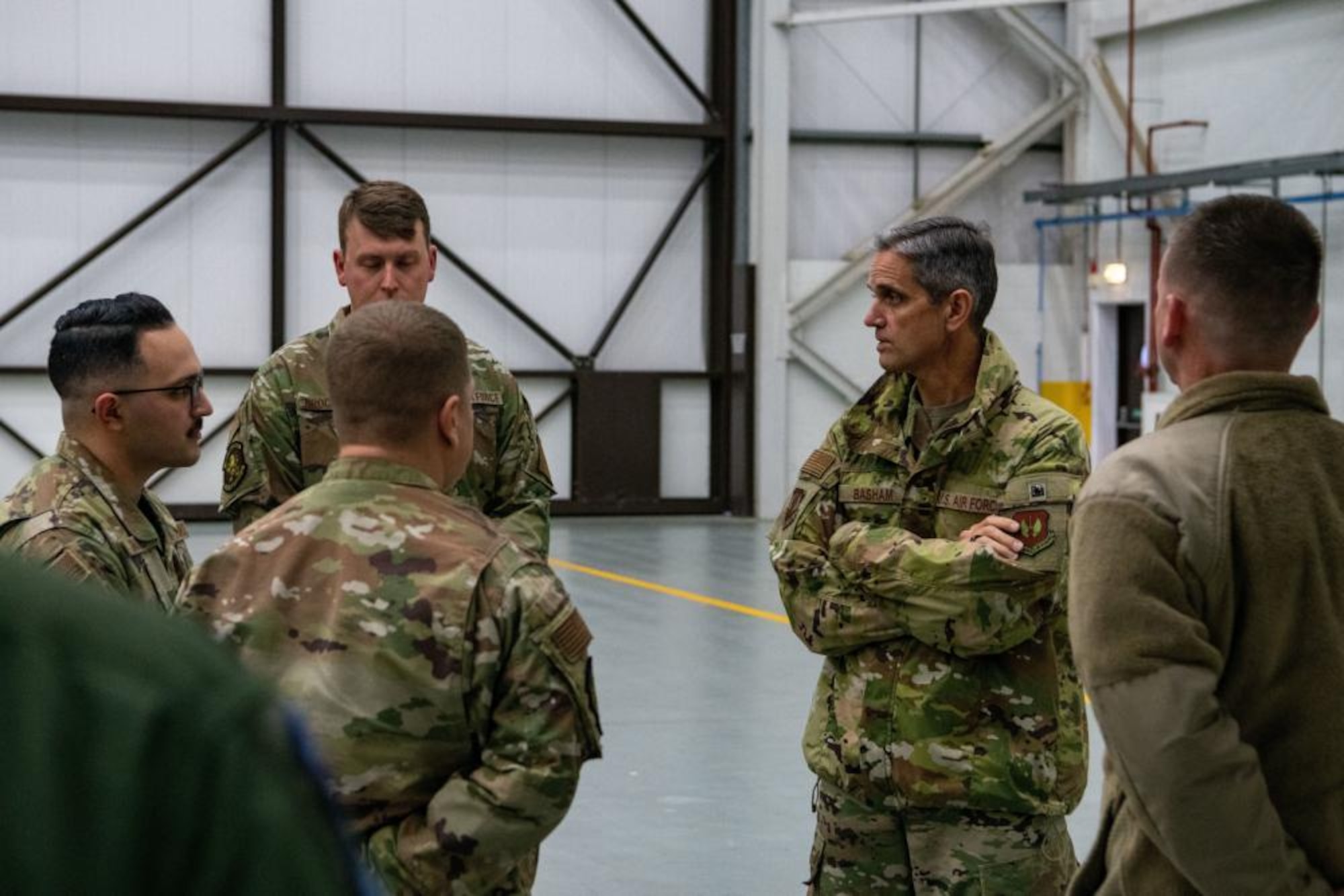 U.S. Air Force Lt. Gen. Steven Basham, U.S. Air Forces in Europe and Air Forces Africa deputy commander, discusses with a group of maintenance Airmen about the capabilities of a KC-135 Stratotanker aircraft at Royal Air Force Mildenhall, England, Nov. 3, 2021. Basham’s visit during exercise Castle Forge allowed him to see how the 100th ARW is implementing future Air Force Warfighting concepts into its training and operations. (U.S. Air Force photo by Senior Airman Nicholas Swift)