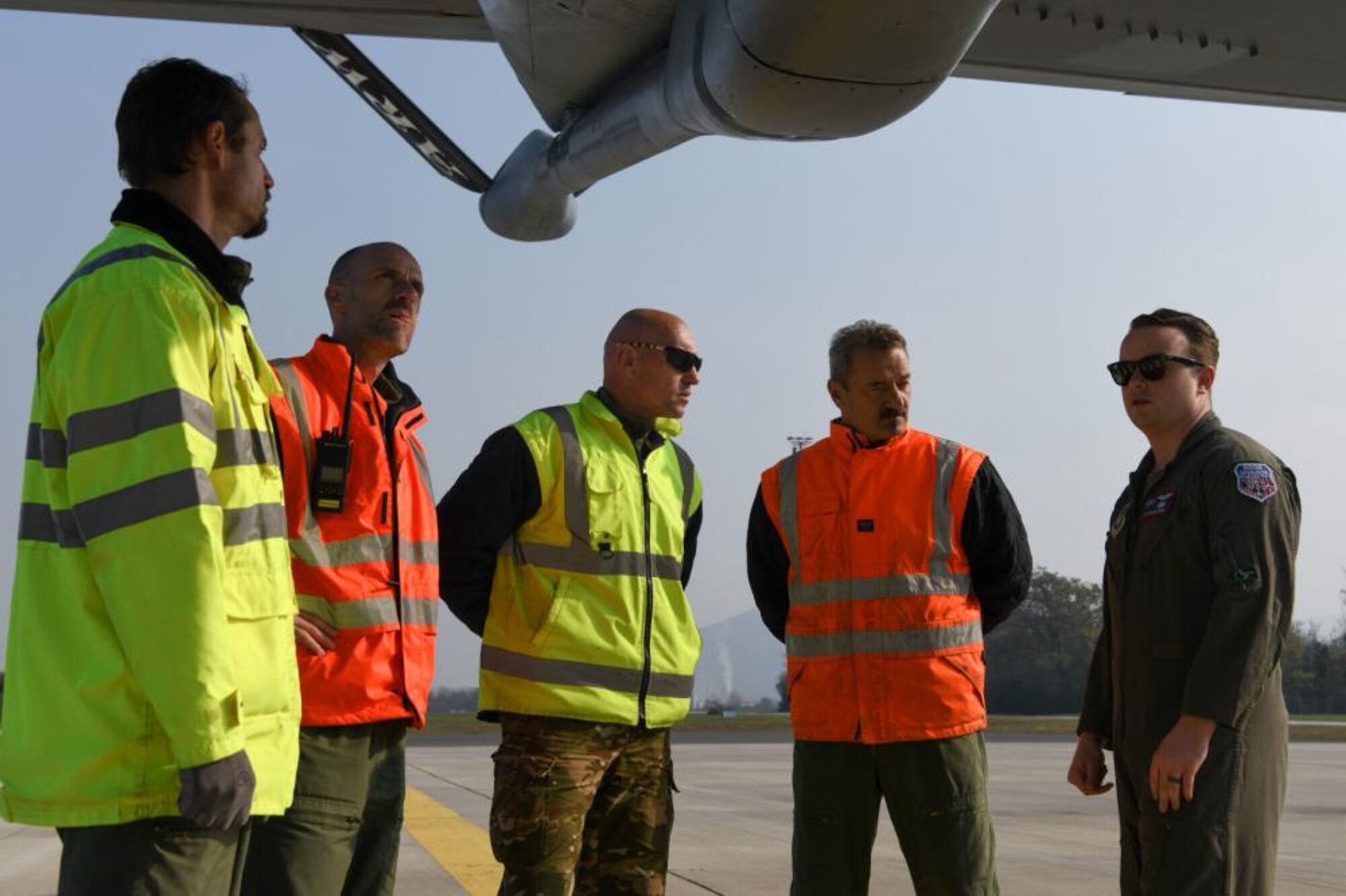 U.S. Air Force Tech. Sgt. Blake Soule, 100th Air Refueling Squadron boom operator, discusses the use of a KC-135 Stratotanker’s boom in refueling operations with Slovenian military officials at Cerklje, Slovenia, Oct. 29, 2021. As part of the KC-135 Stratotanker aircraft tour, Slovenian military officials were given the chance to sit in the boom pod getting a firsthand experience of the boom operators perspective. (U.S. Air Force photo by Senior Airman Nicholas Swift)
