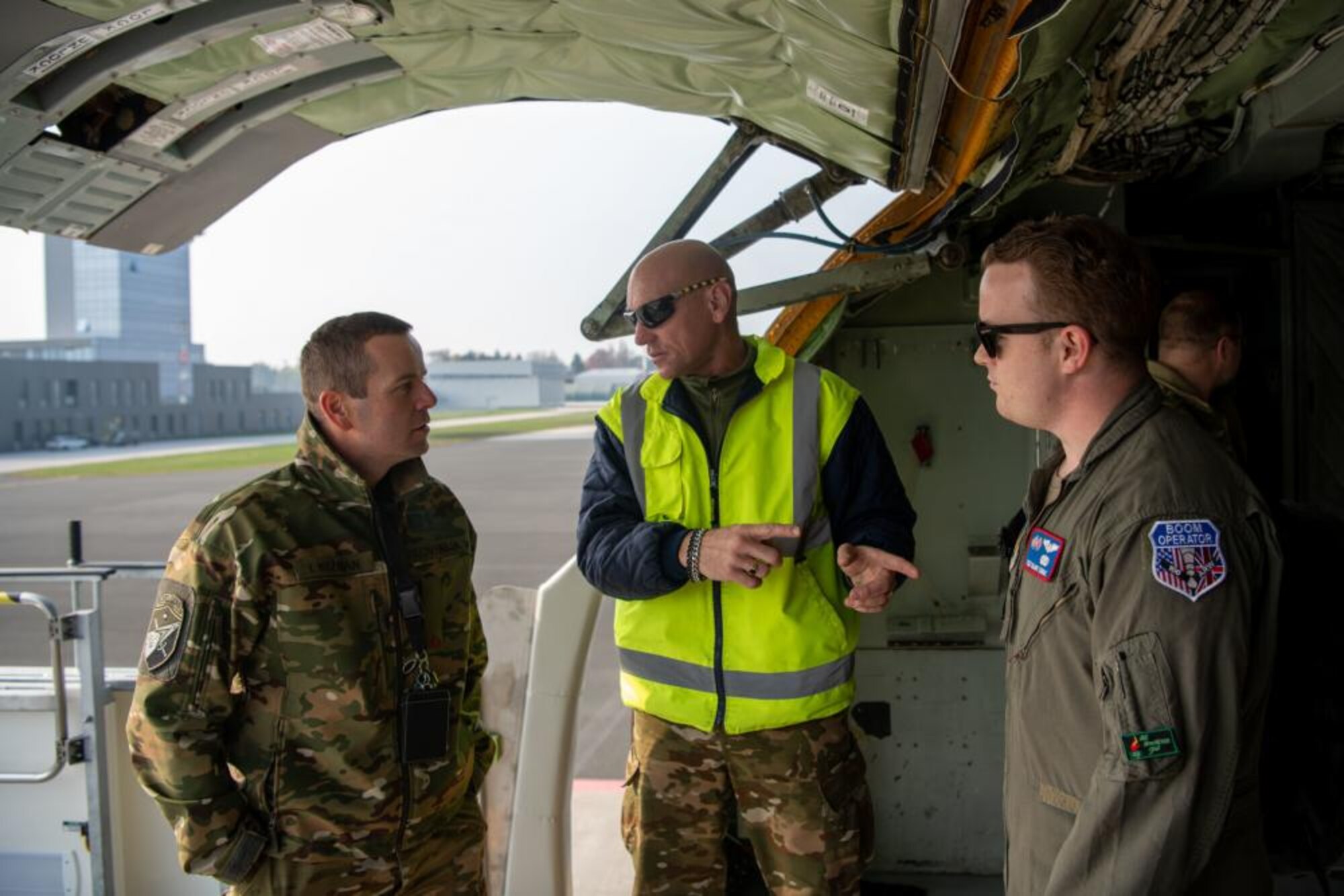 Slovenian military officials stand in the cargo bay opening of a KC-135 Stratotanker aircraft with U.S. Air Force Tech. Sgt. Blake Soule, 100th Air Refueling Squadron boom operator, at Cerklje, Slovenia, Oct. 29, 2021. Soule led a tour of the KC-135 as part of a United States Armed Forces in Europe partnership mission, which introduced Slovenian military to U.S. Air Force refueling operations. (U.S. Air Force photo by Senior Airman Nicholas Swift)