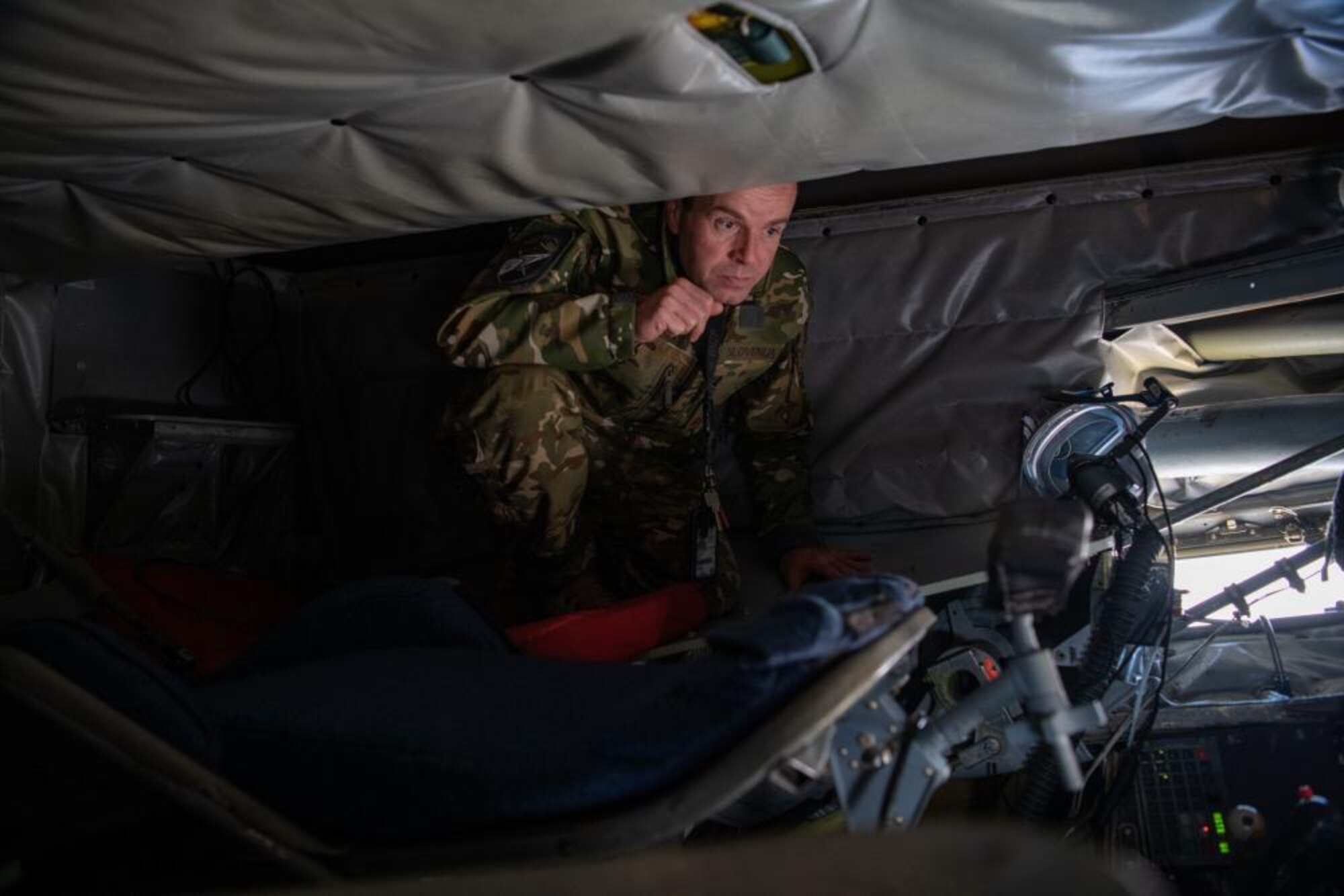 A Slovenian military official inspects the boom pod of a KC-135 Stratotanker, at Cerklje, Slovenia, Oct. 29, 2021. The boom pod, located in the rear end of the aircraft, is designed to have a boom operator lay in a downward facing position for the duration of the refueling process. (U.S. Air Force photo by Senior Airman Nicholas Swift)