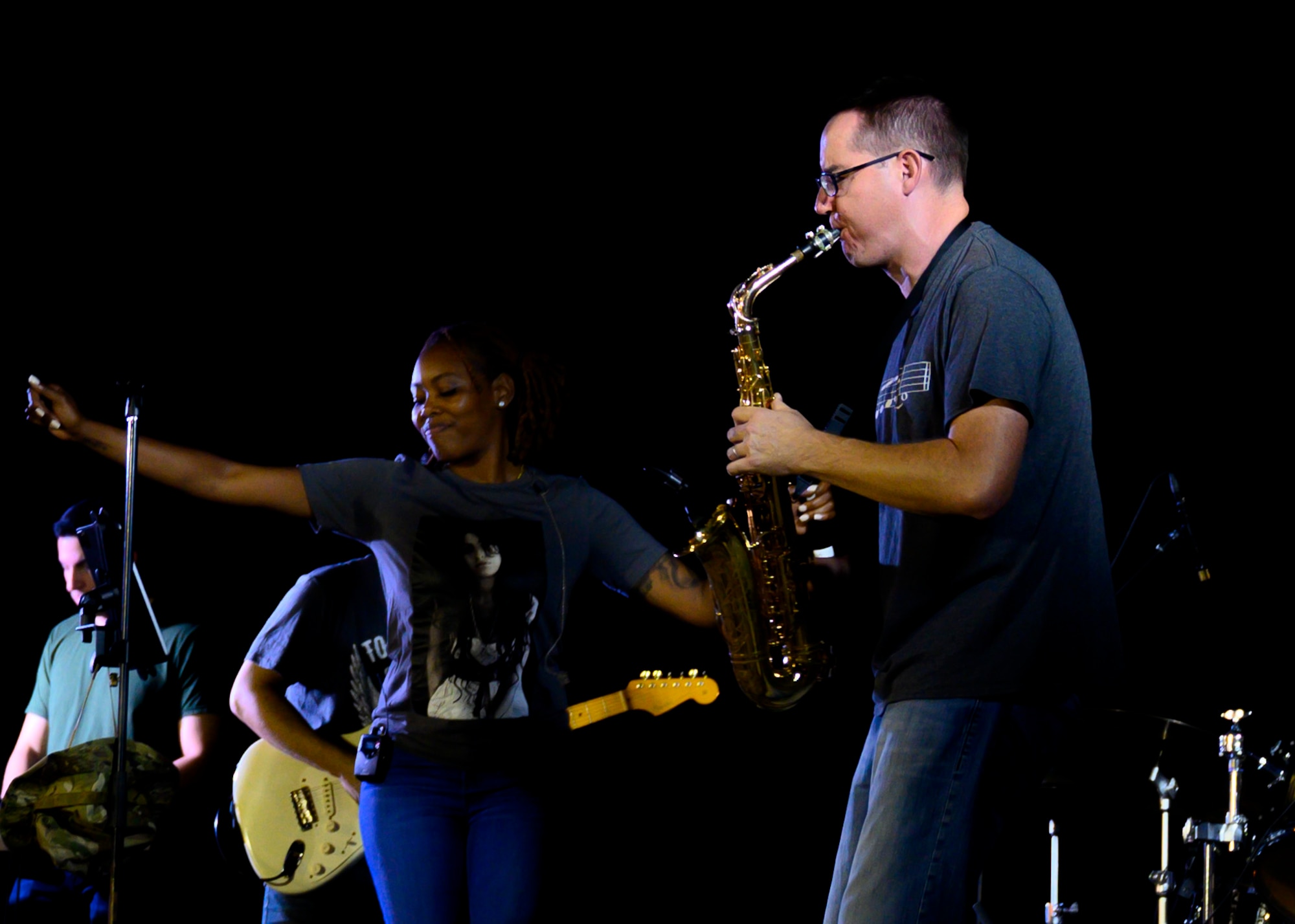 U.S. Air Force Tech. Sgt. Gregory Pflugh, U.S. Air Forces Central Band saxophonist and NCOIC of operations, right, and Senior Airman Me-Lan Smartt, AFCENT Band vocalist, center, perform during a concert at Prince Sultan Air Base, Kingdom of Saudi Arabia, Oct. 16, 2021. The 378th Air Expeditionary Wing hosted two nights of performances in recognition and celebration of the base’s accomplishments throughout the past summer. (U.S. Air Force photo by Senior Airman Samuel Earick)