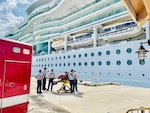 Emergency medical services personnel awaiting patient from cruise ship in Key West, Oct. 20, 2021. The Serenade of the Sea personnel safely transferred the man to emergency medical services and was further transported to Lower Keys Medical Center. (U.S. Coast Guard photo)