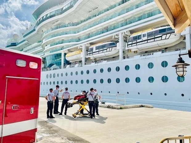 Emergency medical services personnel awaiting patient from cruise ship in Key West, Oct. 20, 2021. The Serenade of the Sea personnel safely transferred the man to emergency medical services and was further transported to Lower Keys Medical Center. (U.S. Coast Guard photo)