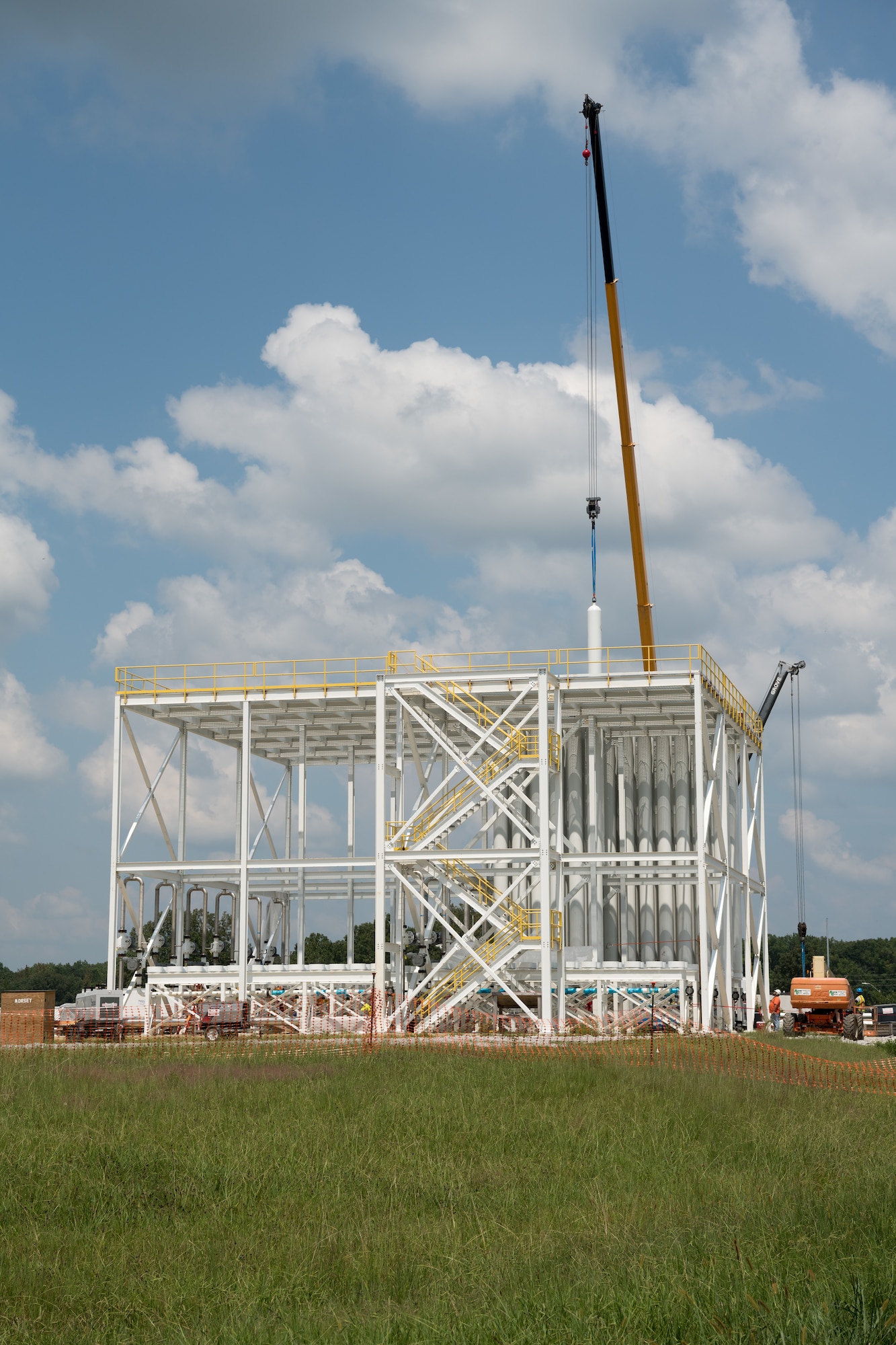 A high-pressure air (HPA) bottle is lifted and lowered into place in the J-5 test facility bottle farm, Aug. 26, 2021, at Arnold Air Force Base, Tenn. The bottle farm will be tied into the HPA distribution network at Arnold AFB to provide other test facilities access to the resource. (U.S. Air Force photo by Jill Pickett)