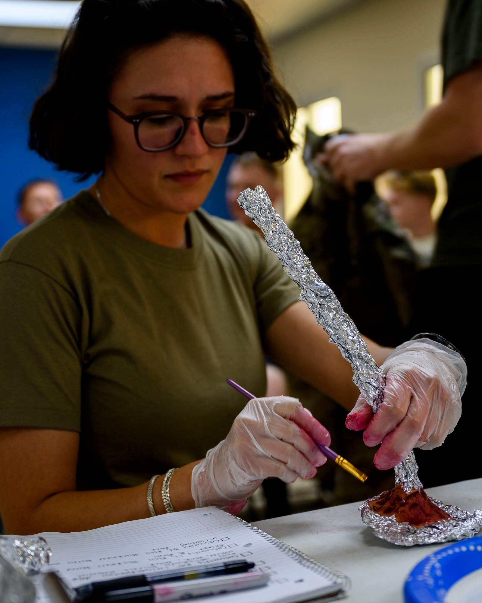 U.S. Army Spc. Stephanie Cameron, 378th Expeditionary Medical Group combat medic specialist, applies makeup to a mock appendage during a mass casualty and missile defense exercise at Prince Sultan Air Base, Kingdom of Saudi Arabia, Oct. 28, 2021.