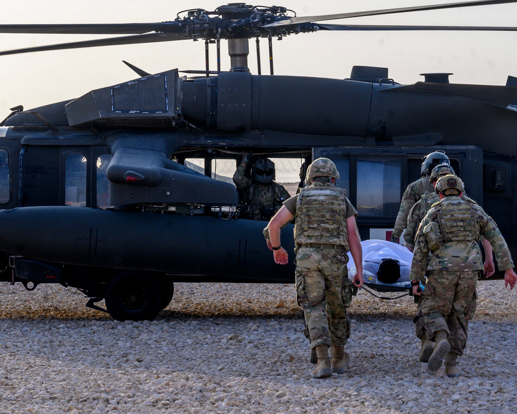 378th Expeditionary Medical Group personnel transport a mock victim of the mass casualty and missile defense exercise to a U.S. Army UH-60 Black Hawk assigned to the 40th Combat Aviation Brigade at Prince Sultan Air Base, Kingdom of Saudi Arabia, Oct. 28 2021.