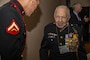 U.S. Marine Corps Staff Sgt. Tom Evans, a World War II veteran, speaks with a Marine from the 1st Marine Division color guard during a 246th Marine Corps Birthday Ball and Last of the First Salute ceremony at Omni La Costa Resort and Spa, Carlsbad, California, Nov. 6, 2021. Marines with 1st MARDIV, past and present, gathered to celebrate the anniversary of the Marine Corps. During the celebration, WWII veterans opened a bottle of cognac called the "Last Man's" bottle, which they had saved since WWII. The bottle was intended to be opened by the last surviving Marine from the Battle of Guadalcanal. Due to the declining number of Marines from the battle, the bottle was opened 77 years later and shared with the Marines in attendance at the ball.