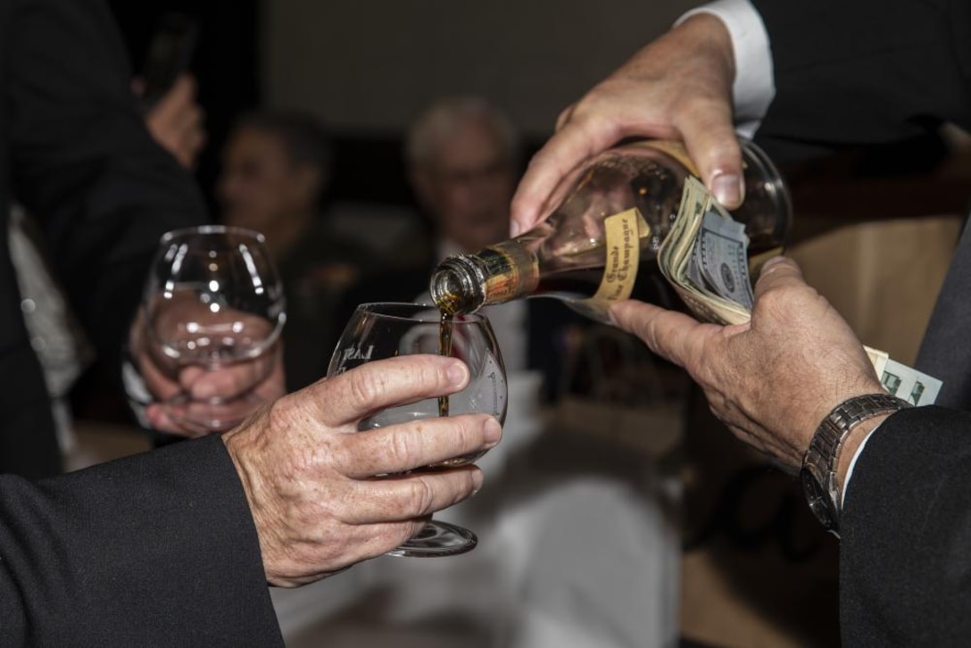U.S. Marines share a bottle of cognac from 1942 during a 246th Marine Corps Birthday Ball and Last of the First Salute ceremony at Omni La Costa Resort and Spa, Carlsbad, California, Nov. 6, 2021. Marines with 1st Marine Division, past and present, gathered to celebrate the anniversary of the Marine Corps. During the celebration, World War II veterans opened a bottle of cognac called the "Last Man's" bottle, which they had saved since WWII. The bottle was intended to be opened by the last surviving Marine from the Battle of Guadalcanal. Due to the declining number of Marines from the battle, the bottle was opened 77 years later and shared with the Marines in attendance at the ball.