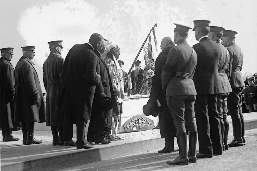 Native American in traditional clothing and other dignitaries at Tomb of the Unknown Soldier.