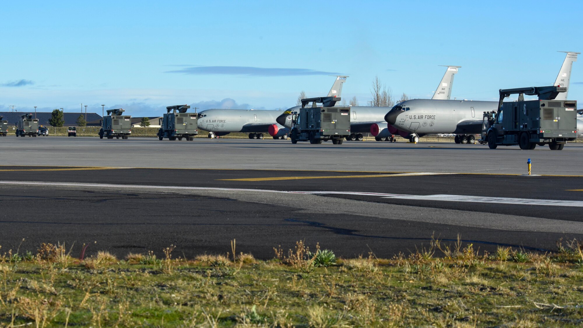 A line of extended-reach aircraft deicers rush to the flightline to prepare aircraft for takeoff during exercise Global Thunder 22, at Fairchild Air Force Base, Washington, Nov. 7, 2021. This U.S. Strategic Command exercise’s fundamental mission is to deter strategic attack, which is an existential threat to the U.S. and its allies. (U.S. Air Force photo by Airman 1st Class Anneliese Kaiser)